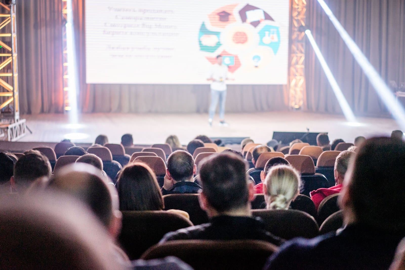 Large auditorium conference with delegates watching the main stage