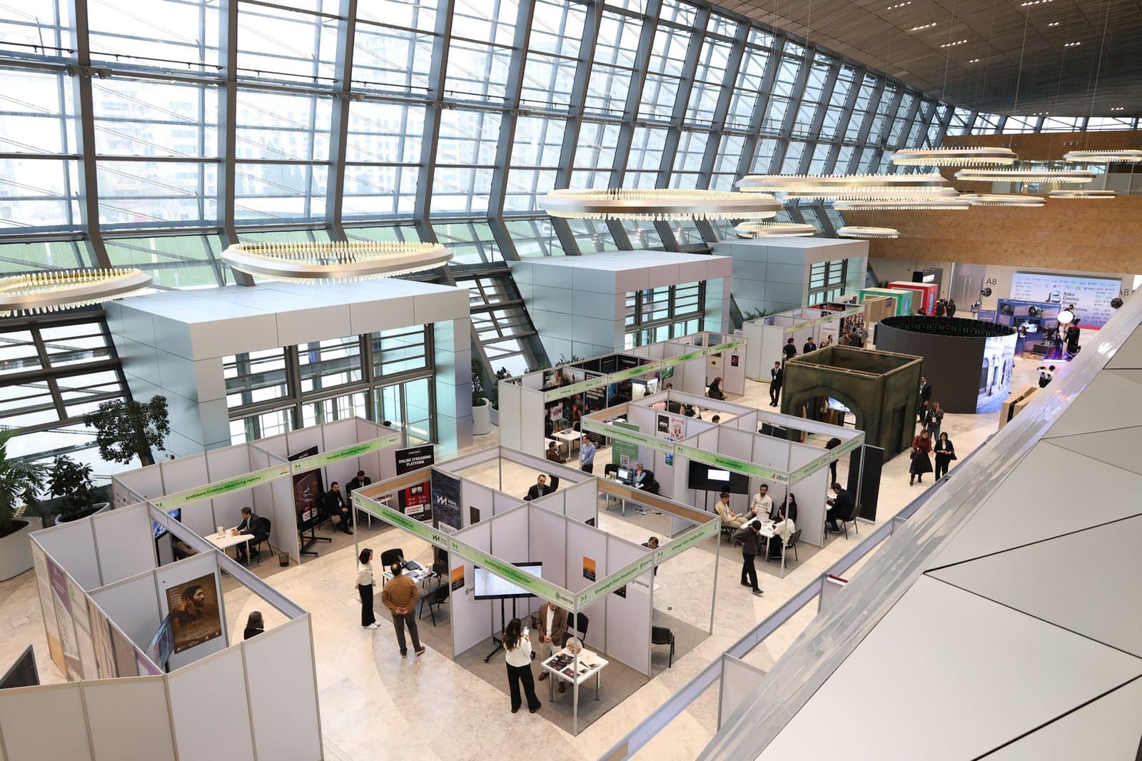 Modern exhibition hall with delegates browsing stalls