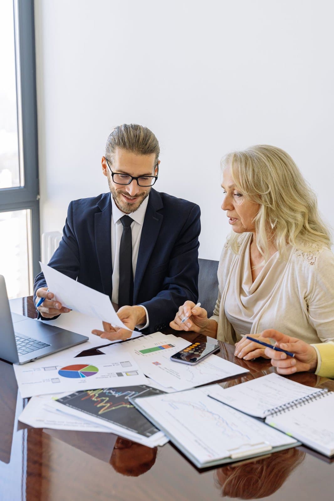 Business professionals reviewing documents at a meeting