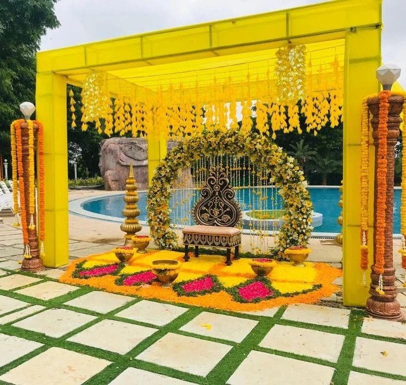 Marigold mandap beside a poolside garden