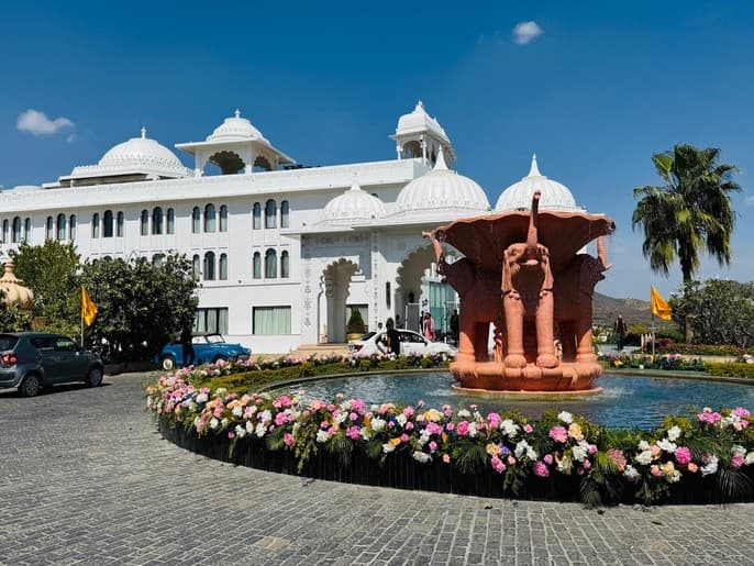 Palace entrance fountain framed by fresh floral arrangements