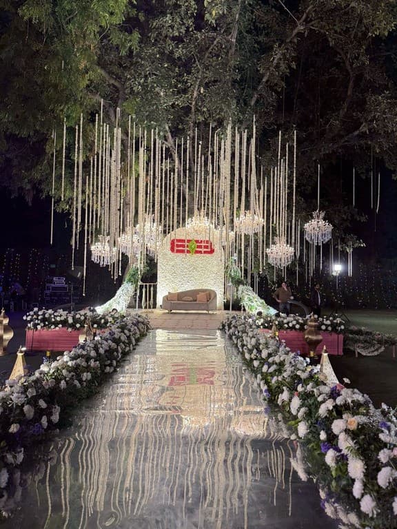 Illuminated floral aisle leading to the ceremony stage